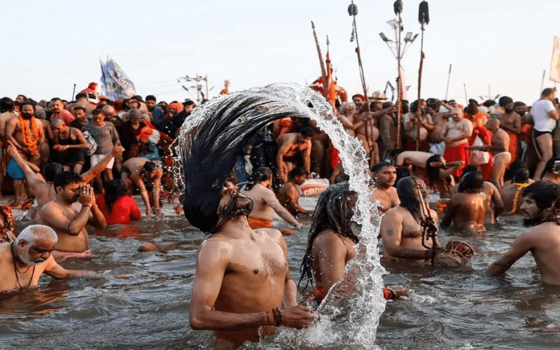 Devotees taking part in the Achla Saptami Bathing 2025 at the Kumbh Mela, seeking spiritual purification in the Ganges River.